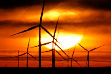 Wind turbines are silhouetted against the rising sun Wednesday, Jan. 13, 2021, near Spearville, Kan. (AP Photo/Charlie Riedel)