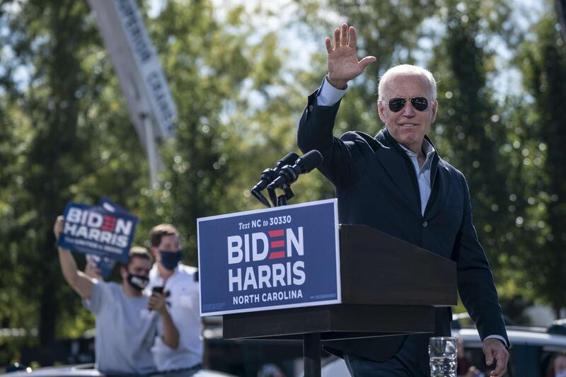 Democratic presidential nominee Joe Biden waves as he departs the stage during a drive-in campaign rally at Riverside High School in Durham, North Carolina. AFP