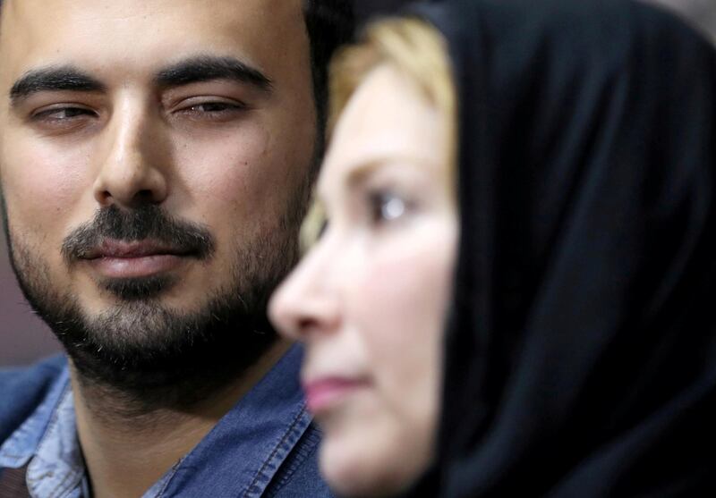 Amjad Yaghi looks at his mother Nevine. Reuters