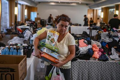 A woman carries toys for children from donations at a hotel in Eilat. AFP