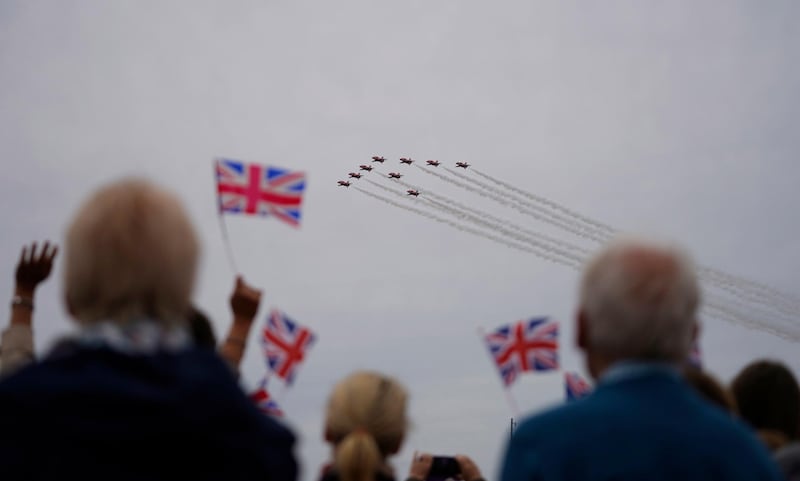 People look at a flypast during the commemorations for the 75th Anniversary of the D-Day landings in Southsea Common, Portsmouth, Hampshire.  EPA