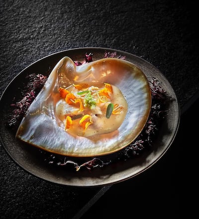 The dish is plated within a giant clam shell. Photo: Smoked Room