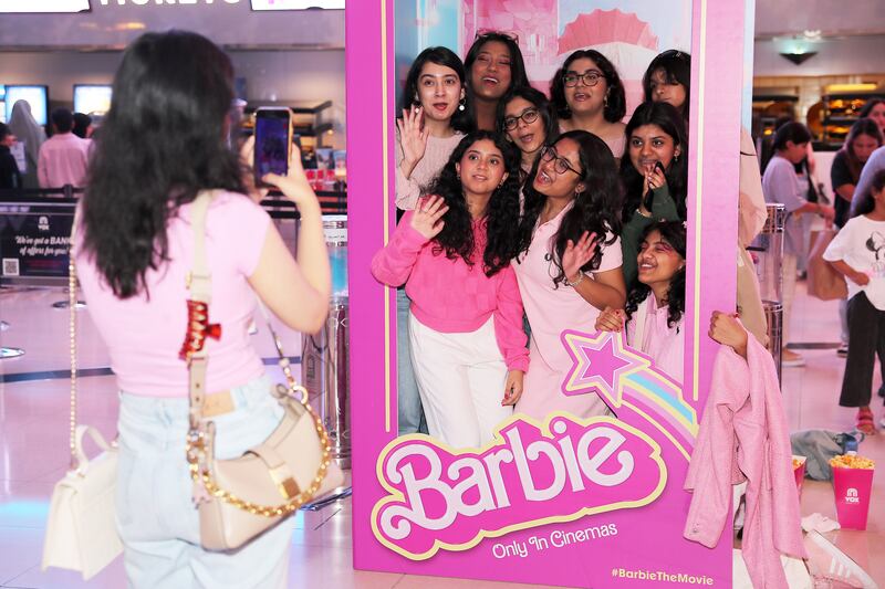 The Barbie movie is now showing in the UAE. Pictured: Barbie fans taking their photos at the interactive Barbie display at Vox cinema at Mall of the Emirates in Dubai. All photos: Pawan Singh / The National
