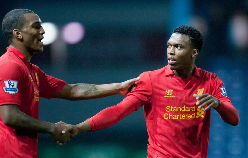 Liverpool's Daniel Sturridge, right, shakes hands with teammate Andre Wisdom during their team's English FA Cup 3rd round soccer match against Mansfield Town at Field Mill Stadium, Mansfield, England, Sunday, Jan. 6, 2013. (AP Photo/Jon Super)