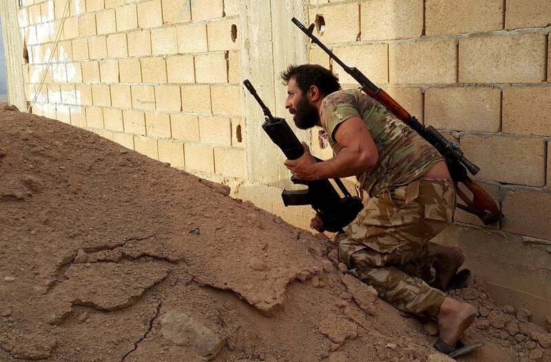 A member of forces loyal to Libya's eastern government carries his weapon during clashes with the Shura Council of Libyan Revolutionaries in Benghazi. Reuters