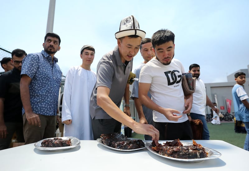 Worshippers enjoy food during the Eid celebration at Al Salam Community School. Chris Whiteoak / The National