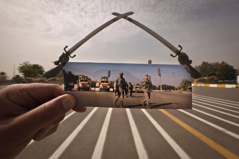 This Thursday, March 14, 2013 photo shows a general view of the crossed swords monument at the site of an Associated Press photograph taken by Karim Kadim of U.S. soldiers taken on Nov. 16, 2008. The crossed-sword archways Saddam Hussein commissioned during Iraq’s nearly eight-year war with Iran stand defiantly on a little-used parade ground inside the Green Zone, the fortified district that houses the sprawling U.S. Embassy and several government offices. Iraqi officials began tearing down the archways in 2007 but quickly halted those plans and then started restoring the monument two years ago. (AP Photo/Maya Alleruzzo) *** Local Caption ***  APTOPIX Mideast Iraq On This Site.JPEG-04d00.jpg