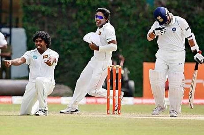 Lasith Malinga, left, the Sri Lanka paceman, took his 100th Test wicket yesterday when he dismissed India's Sachin Tendulkar, right.