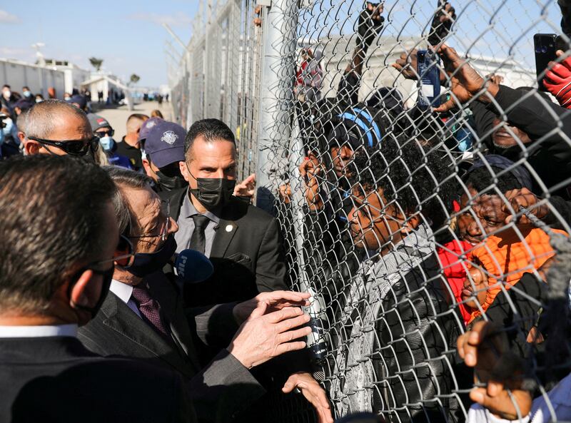 Cypriot President Nicos Anastasiades talks to migrants at a refugee camp, on the outskirts of Nicosia, Cyprus. Reuters