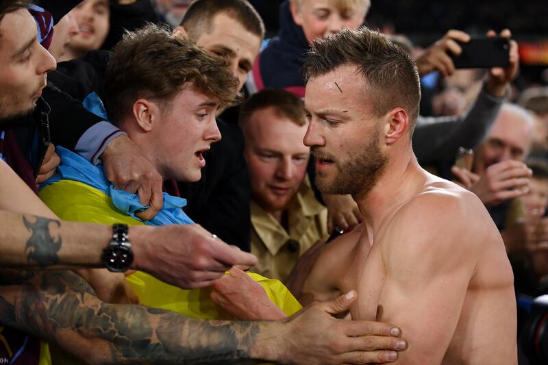 Andriy Yarmolenko of West Ham United gives his match shirt to a fan holding a Ukrainian flag to indicate peace and sympathy with Ukraine after victory during the Europa League Round of 16 second leg against Sevilla at London Stadium on March 17, 2022 in London, England. Getty Images