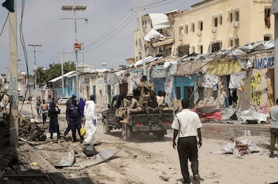 Police and military officials comb the scene of an Al Shabaab militant attack, in Mogadishu, Somalia. Reuters