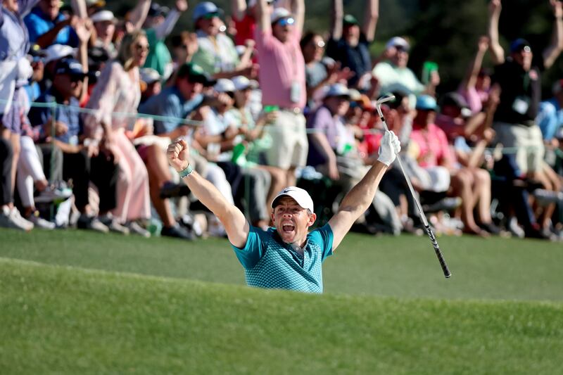 Rory McIlroy of Northern Ireland chips in for birdie from the bunker on the 18th green during the final round of the Masters at Augusta National Golf Club in Augusta, Georgia. AFP