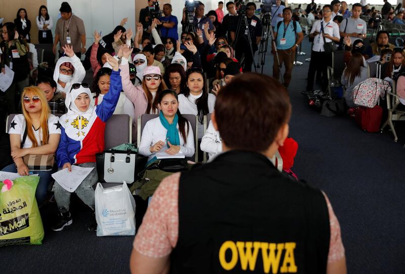 Filipino workers who were repatriated from Kuwait take part in a dialogue with a Department of Labour official at Ninoy Aquino International Airport in Paranaque, Metro Manila, Philippines February 12, 2018.  REUTERS/Erik De Castro