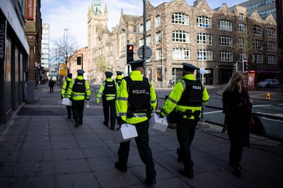 Police officers patrol around the Grand Central Hotel in Belfast. EPA