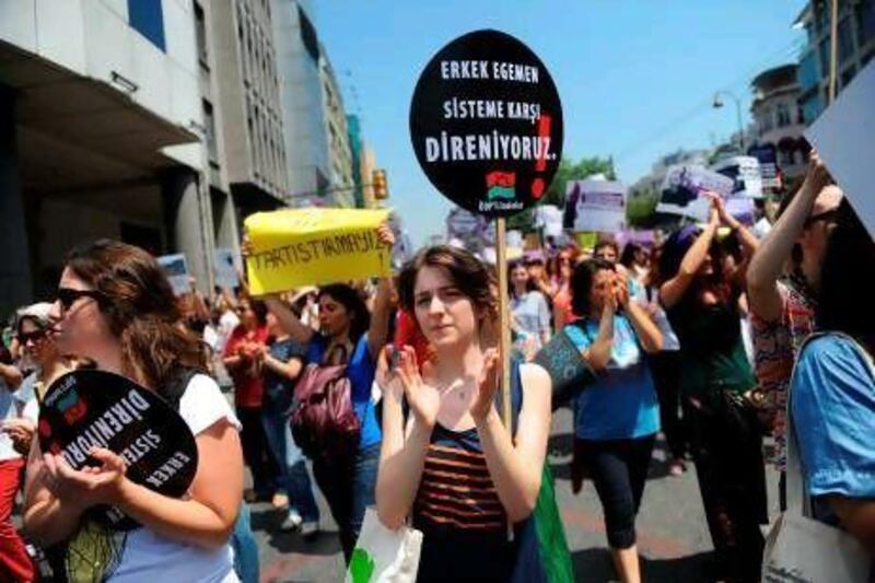 A Turkish woman holds a placard that translates as "No men-dominant system" during a large pro-abortion protest in Istanbul on Sunday.