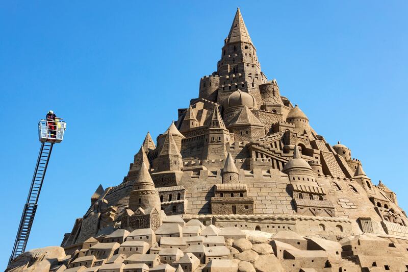 The record judges check a sand castle at the Sand Sculpture Festival in Binz on the island of Ruegen, northern Germany. The sculpture is 17.66 meters high and consists of 11,000 tons of sand. The artwork received the 'Greatest Sandcastle in the World' award from Guinness World Records.  EPA