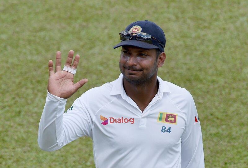 Sri Lanka's Kumar Sangakkara waves to suporters on Sunday, his final innings of Test cricket, as his side chased India in Colombo. Ishara S Kodikara / AFP / August 23, 2015  