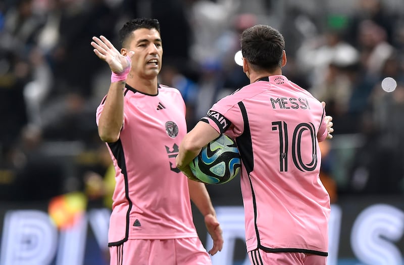 Inter Miami striker Luis Suarez, left, congratulates teammate Lionel Messi after the latter converted a penalty to make it 3-2. Al Hilal went on to win the game 4-3. EPA