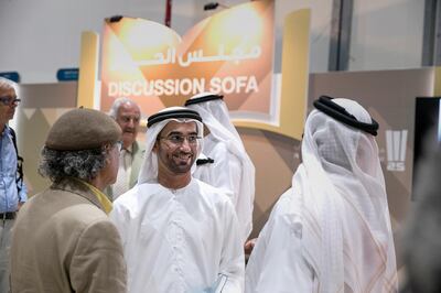ABU DHABI, UNITED ARAB EMIRATES, May 11, 2015:  
(C) Sultan al Amimi, Director, Poetry Academy, Abu Dhabi Heritage Festival Committee, visits with guests after attending a panel at the 2015 Abu Dhabi Book Fair, remembering Mohammed Khalaf Al Mazrouei (not pictured), a heritage adviser to the Crown Prince and former chairman of Abu Dhabi Media who died in a car crash in November last year. (Silvia Razgova / The National)  (Usage: May 11, 2015, Section: NA, Reporter: Anam Rizvi) *** Local Caption ***  SR-150511-bookfair15.jpg