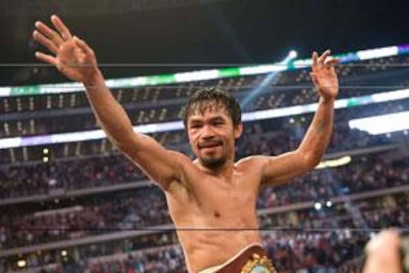 Manny Pacquiao  of the Philippines celebrates after beating Ghana's Joshua Clottey during their World Boxing Organisation (WBO) Welterweight title fight.