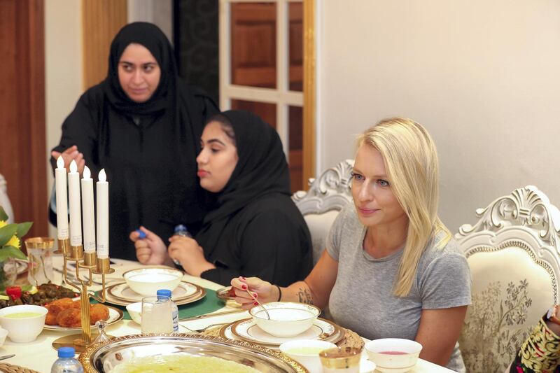 Ras al Khaimah, United Arab Emirates - May 26, 2019: Jana Vintrova (R) 35 from the Czech Republic. Emirati Iftar at Hajar Al Mansouri house as part of the Emirati values iftar project led by the Federal Youth Foundation aims to educate people on traditional UAE values. the project will see Emiratis urged to host expatriates for iftar during Ramadan. Sunday the 26th of May 2019. Ras al Khaimah. Chris Whiteoak / The National