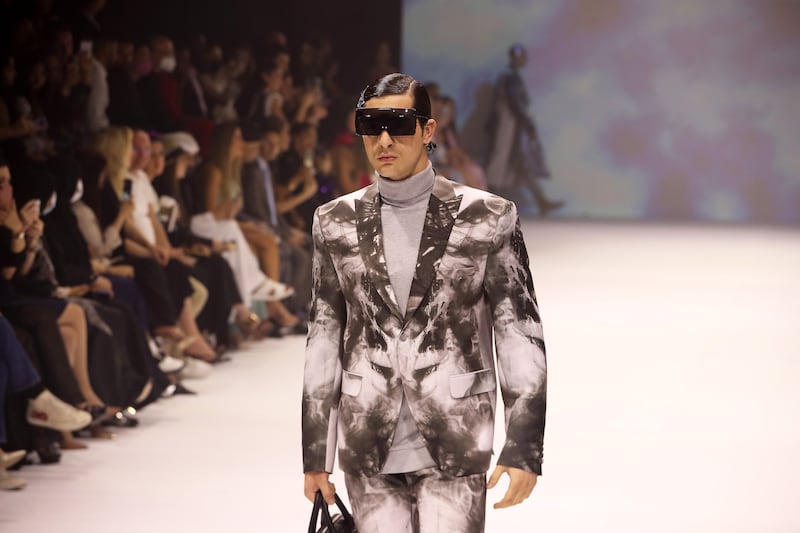 A male model walks the runway during the Michael Cinco show at Arab Fashion Week in Dubai.