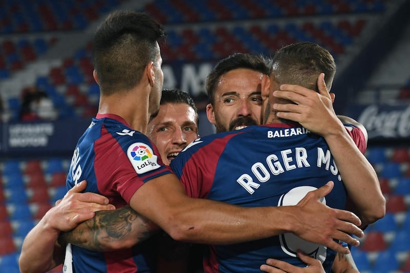 Levante's Spanish midfielder Jose Luis Morales (C) celebrates with teammates after scoring their second. AFP