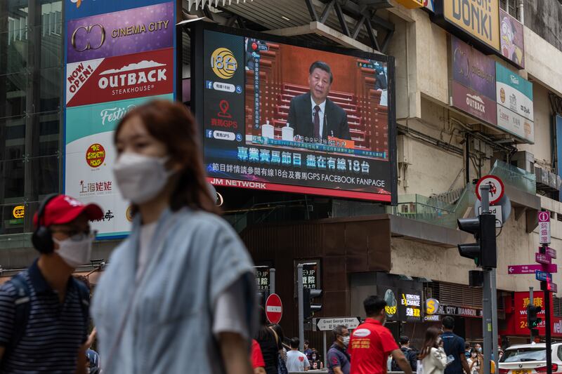 A screen shows a news report about Mr Xi addressing the congress in Hong Kong. EPA