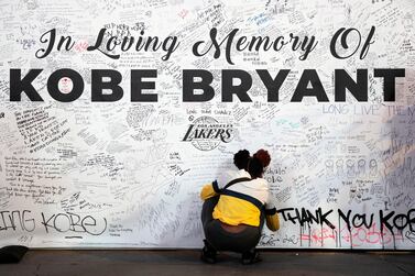 epa08174277 A woman writes on a large board as fans gather at LA Live entertainment complex, across the street from the Staples Center - home of the Los Angeles Lakers - to pay their respects for late former Lakers player Kobe Bryant, in Los Angeles, California, USA, 28 January 2020. According to media reports, former Los Angeles Lakers guard Kobe Bryant died in a helicopter crash in Calabasas, California, USA on 26 January 2020. He was 41. His daughter Gianna, 13, and seven other people also died in the crash. EPA/ETIENNE LAURENT
