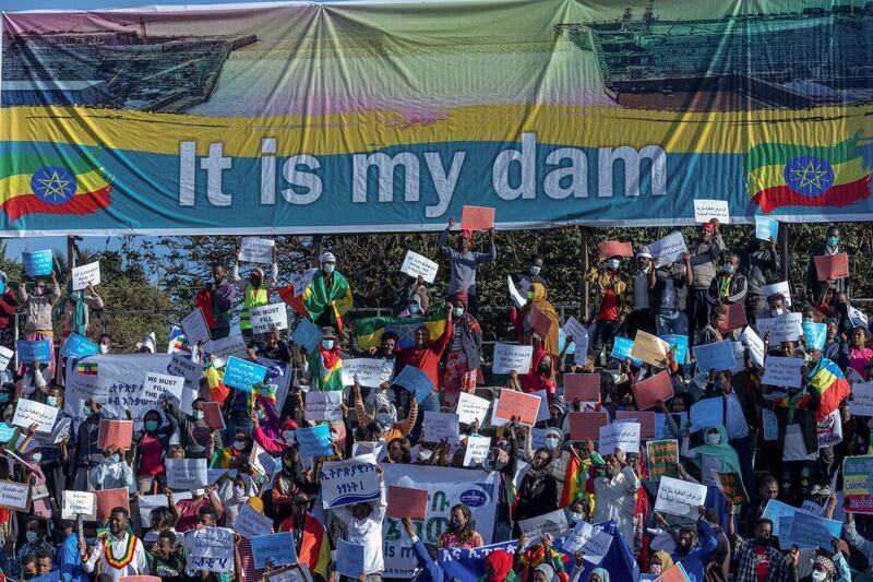 Ethiopians below a banner referring to the Grand Ethiopian Renaissance Dam. AP