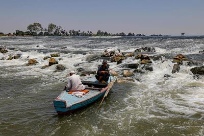 Fishing on the Nile during a heat wave in Al Qanater Al Khayreya, on the outskirts of Cairo, on Wednesday.  AFP