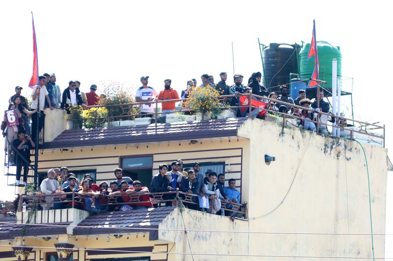 Spectators watch the match between Nepal and UAE from rooftops near the Mulpani Cricket Ground in Kathmandu on Friday