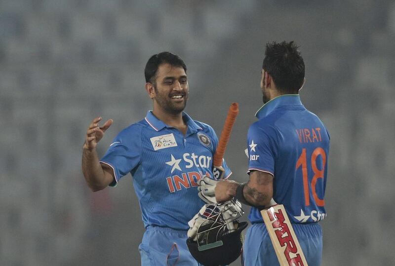 India’s captain MS Dhoni, left, celebrates with his teammate Virat Kohli after winning the Asia Cup Twenty20 international cricket match against Sri Lanka in Dhaka, Bangladesh, Tuesday, March 1, 2016. (AP Photo/A.M. Ahad)