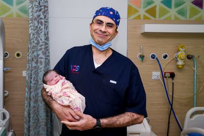 Baby Ayla, pictured with consultant Walid El-Sherbiny, was born at 12.01am, weighing 3.61kg, to an Egyptian couple in Abu Dhabi. Photo: Medeor Hospital