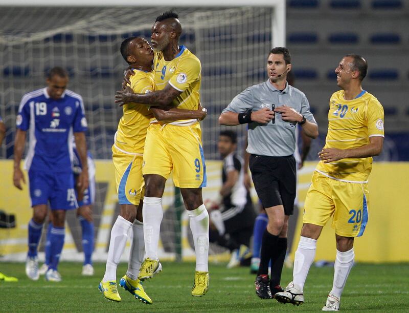  Djibril Cisse from Al Gharafa of Qatar, 3rd left, hugs his team mate Majdi Siddiq after he scores the first goal against Al Nasr of UAE during a AFC Champions League match  in Dubai, United Arab Emirates, Tuesday, April 2, 2013. (AP Photo/Kamran Jebreili) *** Local Caption ***  Mideast Emirates Soccer Champions League.JPEG-0987c.jpg