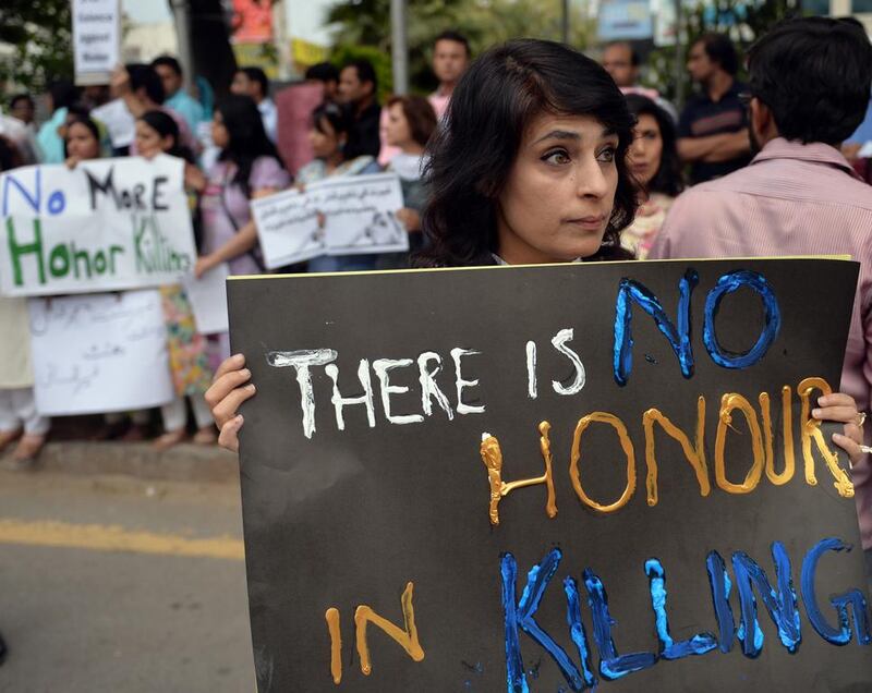 A protest in Islamabad on May 29, 2014 against the so-called honour-killing of pregnant woman Farzana Parveen who was beaten to death with bricks by members of her own family for marrying a man of her own choice in Lahore.  Aamir Qureshi / AFP 