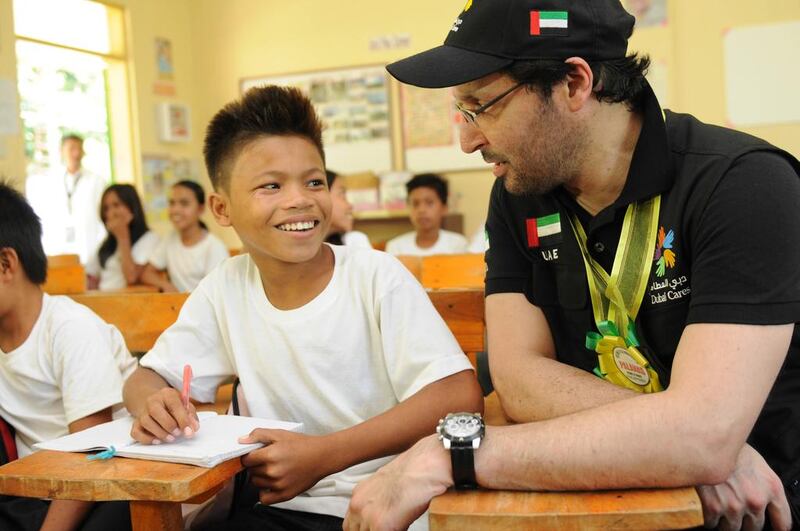 Dubai Cares CEO Tariq Al Gurg speaks to a student at one of the schools in the province of Masbate that benefited from the US$2 million Raise program, which aims to keep young, marginalized students, mostly girls, in school. Photo courtesy of Dubai Cares