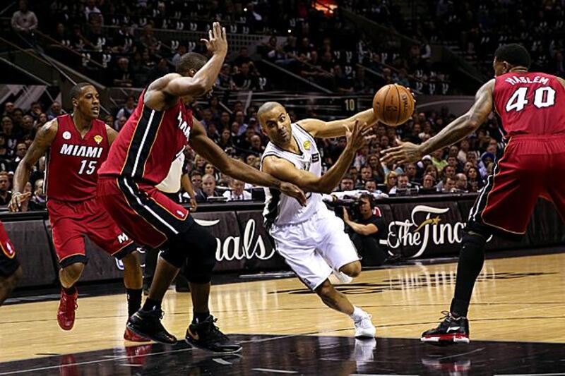 SAN ANTONIO, TX - JUNE 11: Tony Parker #9 of the San Antonio Spurs drives on Chris Bosh #1 of the Miami Heat in the first quarter during Game Three of the 2013 NBA Finals at the AT&T Center on June 11, 2013 in San Antonio, Texas. NOTE TO USER: User expressly acknowledges and agrees that, by downloading and or using this photograph, User is consenting to the terms and conditions of the Getty Images License Agreement.   Mike Ehrmann/Getty Images/AFP== FOR NEWSPAPERS, INTERNET, TELCOS & TELEVISION USE ONLY ==

