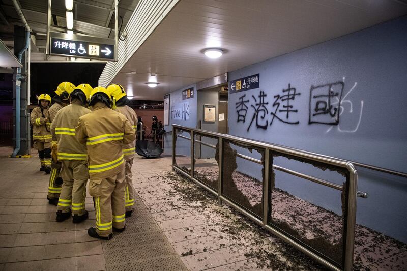 Firefighters work at Kowloon Tong MTR after being vandalized during protests in Hong Kong. Getty Images