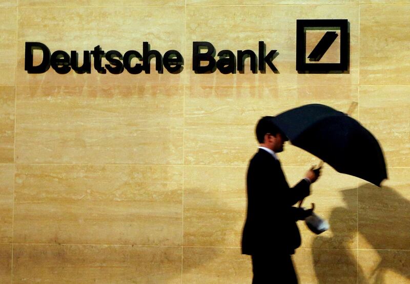 FILE PHOTO: A man walks past Deutsche Bank offices in London, Britain, December 5, 2013. REUTERS/Luke MacGregor/File Photo