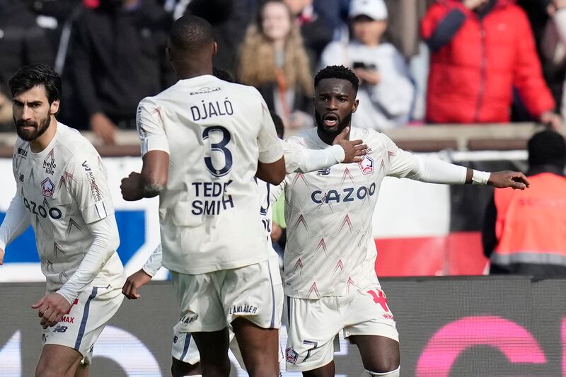 Lille's Jonathan David, right, celebrates with teammates after scoring to make it 2-2. AP