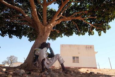 A man whose son is among those who were kidnapped by gunmen sit under a tree at the Government Science Secondary school in Kankara, northwestern Katsina State, Nigeria. AFP Photo