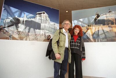 Christo (L) and Jeanne-Claude (R) pose for a photo at the National Gallery of Art in Washington, DC 29 January 2002 during a press preview for the first US survey encompassing four decades of art by the couple most famously know for wrapping of the Pont Neuf in Paris and the Reichstag in Berlin.  Christo and Jean-Claude are currently working on a project on the Arkansas River in Colorado, begun in 1992, which will be installed for two weeks during the summer in 2004 at the earliest.  The exhibit at the National Gallery will run from 03 February to 23 June.  AFP PHOTO/ROBYN BECK (Photo by ROBYN BECK / AFP)