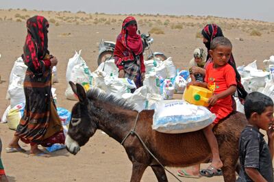 Yemeni families receive flour rations and other basic food supplies from charities in the province of Lahj, in southern Yemen.  AFP
