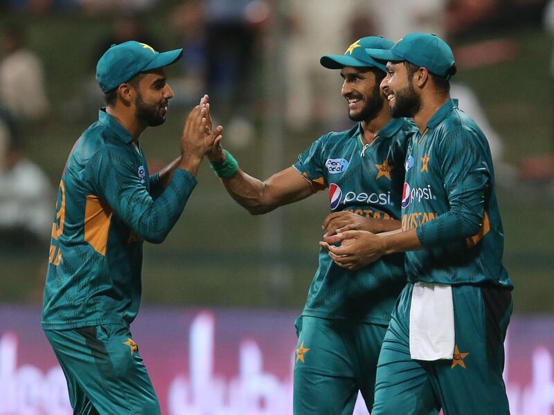 In this picture taken on October 24, 2018, Pakistan cricketer Hasan Ali celebrates with teammates after dismissing Australian cricketer Adam Zampa during the first Twenty20 cricket match between Australia and Pakistan at Sheikh Zayed Stadium in Abu Dhabi. / AFP / -
