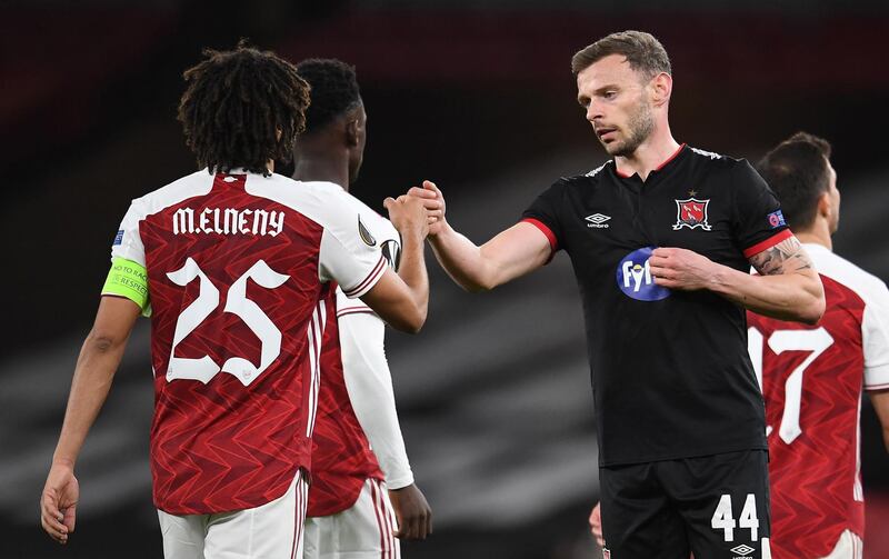 Mohamed Elneny of Arsenal bumps fists with Andy Boyle of Dundalk. EPA