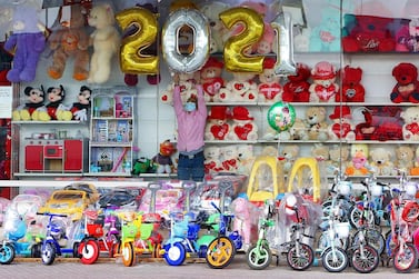 A vendor decorates his toy store ahead of the New Year in Kuwait City. AFP