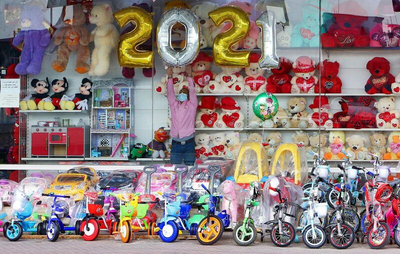 A vendor decorates his toy store ahead of the New Year in Kuwait City on December 31, 2020. / AFP / YASSER AL-ZAYYAT
