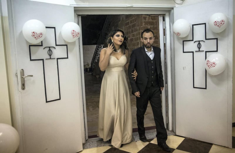 Rimon Ayyad, 28, with his wife Marina, 19, from Cairo as they arrive to celebrate their recent marriage with relatives a at a hall in the compound of the Greek Orthodox Church of Saint Porphyrius in Gaza City. She moved to Gaza to be with him and their wedding is one of the few unions in the Christian community this year.  

ÒIÕm more optimistic this year,Ó said the new groom, who studied nursing and hospital administration but, like so many here, is now unemployed. ÒIÕve just started my new life.Ócompound at the Church of Saint Porphyrius in Gaza City on December 20,2018.(Photo by Heidi Levine for The National).