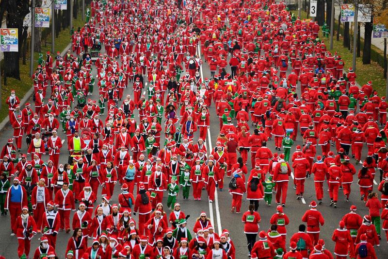 People dressed as Santa Claus take part in the Santa Claus run in Madrid. AFP